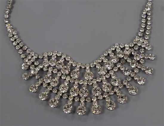 An ornate white metal and paste set three row fringe necklace, approx. 44cm.